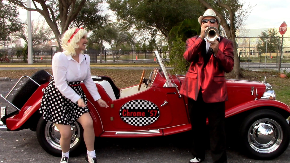 Show Band on Wheels is the ultimate 50s band in Sarasota specializing in 50s entertainment, Oldies band, Sock hop, atmosphere entertainment, parades, and streetmosphere entertainment, interactive entertainment, as a oldies duo for 50s theme entertainment, and sock hop parties with a live band look no further than Show Band on wheels for your Grease theme party entertainment with a muscle car or antique car for your event. DJ on wheels in a 1950s muscle car. 